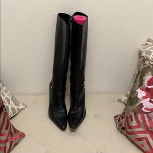 Black long leather boots with the silver buckle.